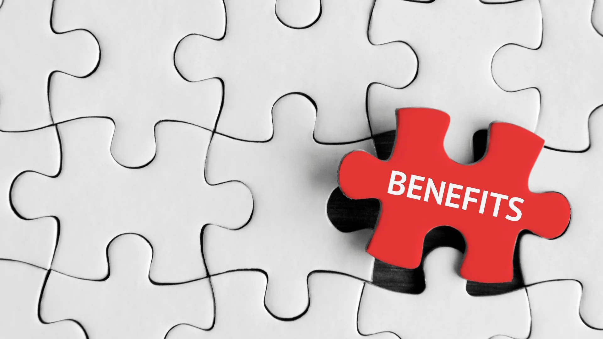 Red jigsaw piece labelled Benefits standing out from a white puzzle